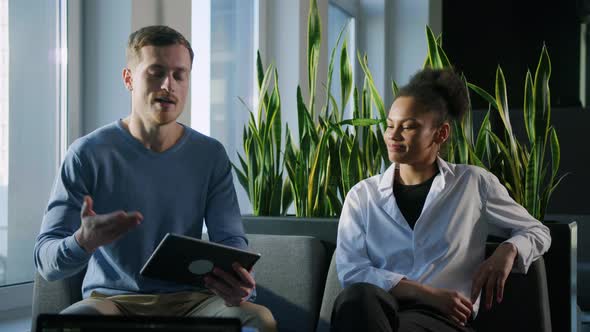 A Small Talk Between Two Colleagues in the Lobby of the Office alt