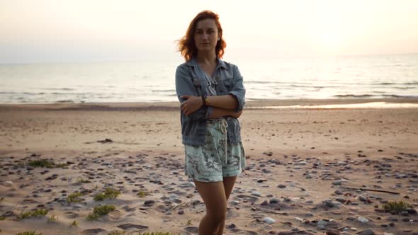 Dolly In: Young LGBT Woman Wears Rainbow Bracelet and Looks at Camera alt