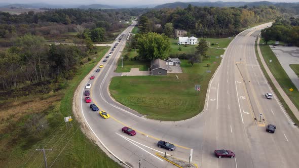 Rural highway in western Wisconsin with corvettes touring through countryside. Trees and mountains.