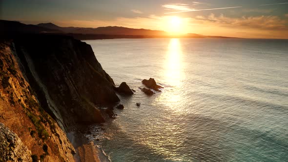 Asturias Coast. Sunset over Cabo Busto Cliffs, Spain. alt