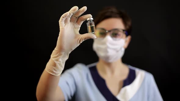 A Doctor or Nurse in Nitrile Gloves Holds in His Hand a Vaccine Vaccinated Against Influenza