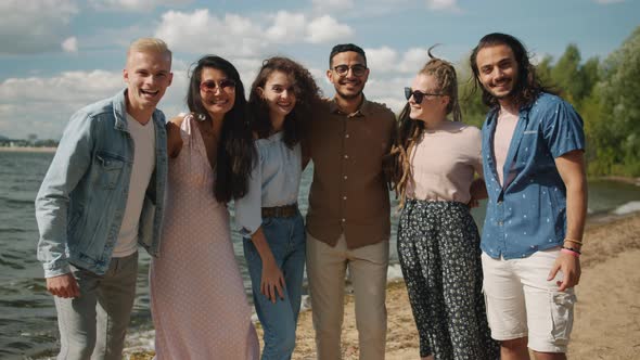 Portrait of Happy Men and Women Standing Outdoors on Beach Smiling Laughing Enjoying Summer alt