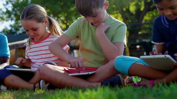 Kids using digital tablet in the playground alt