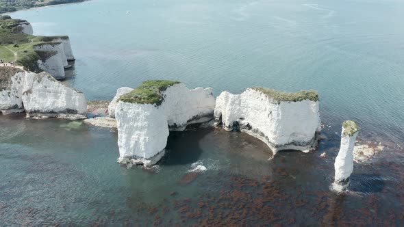 Close up circling drone shot of old harry rocks white cliff rock formations in the UK alt