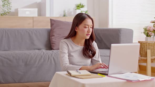 Adorable little kid girl giving fresh milk and take care her mother during working at home alt