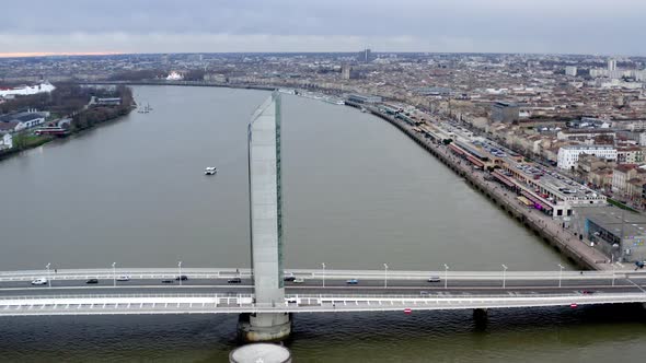 Jacques Chaban-Delmas Bridge in Bordeaux France with car traffic and Garonne river below, Aerial dol alt