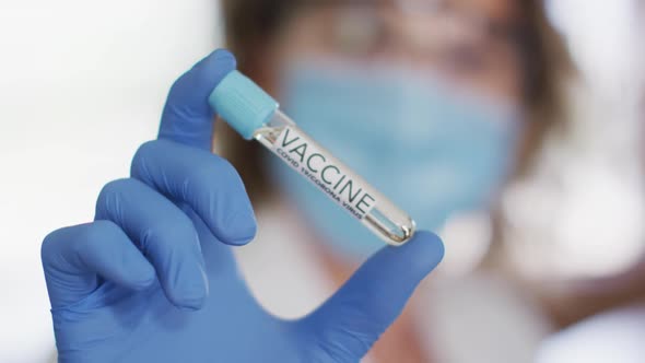 Caucasian female teacher wearing face mask at school, looking at a probe. Education back to school h alt