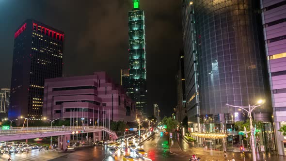 Taipei City at Night in Taiwan with Illuminated Financial Center. Timelapse of Transport Moving on