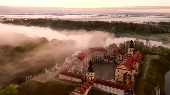 Amazing Dawn in the Foggy Nesvizh, Fog Over the River. Nesvizh. Ancient Castle . Belarus alt