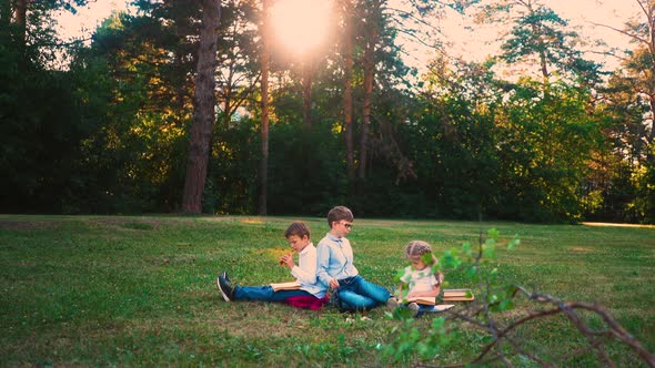 Student Do Home Task with Sister Sitting on Lawn alt