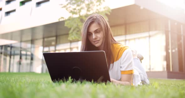 Woman with Laptop Working Outdoors Sunset