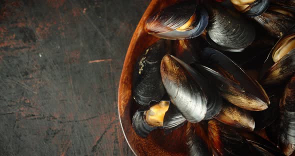 Cooked Mussels in a Wooden Plate.  alt
