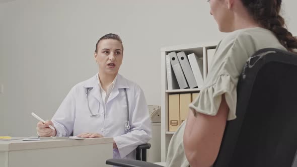 Gynecologist Giving Consultation to Pregnant Woman alt