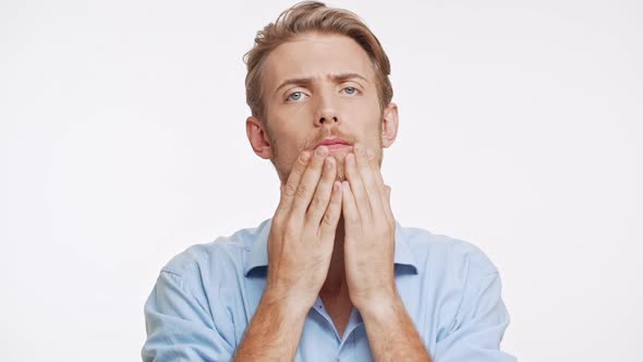 Good Looking Caucasian Male with Light Brown Hair and Blue Eyes Adjusts His Beard and Moustage on alt