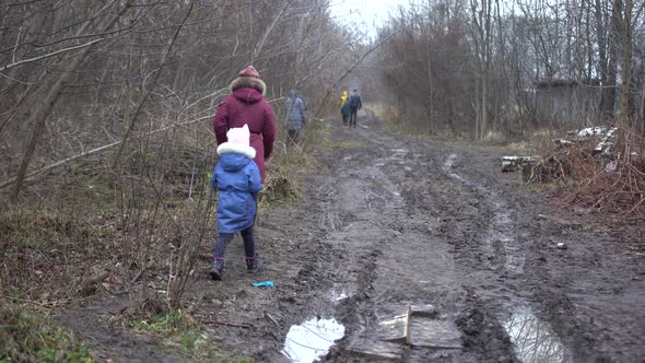 People Walk Gloomy Park in January alt