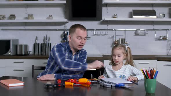 Dad Asking Little Girl To Choose Screwdriver Tool alt