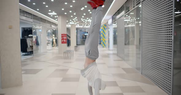 Breakdancer Doing Back Flips in Hallway of Modern Shopping Mall alt