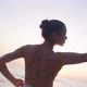 Live Camera Follows Movement of Slim Graceful Ballerina Dancing at Sunset on Sea Shore in Slow - VideoHive Item for Sale