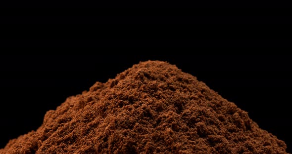 Nutmeg, myristica fragans, Powder turning against Black Background, Slow Motion 4K alt