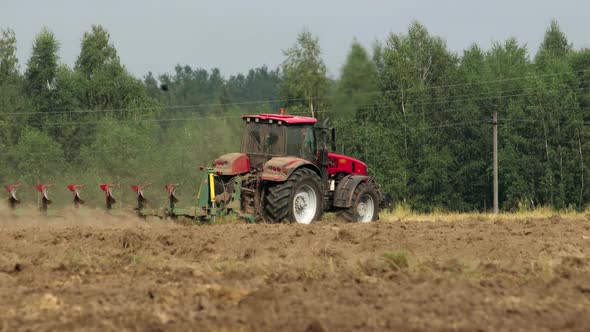 Tractor Cultivates Arable Land alt