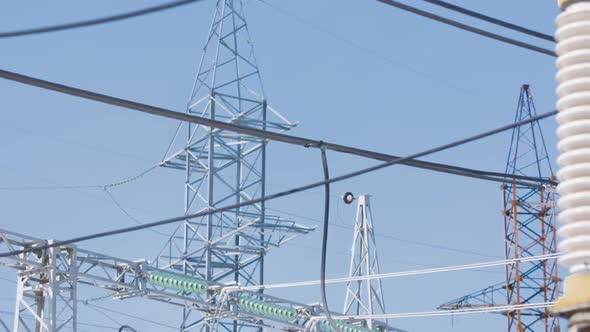 Power poles on background of blue sky alt