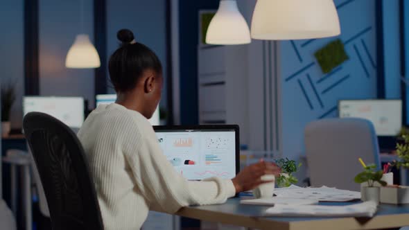 Busy African Business Woman Analysing Financial Reports alt