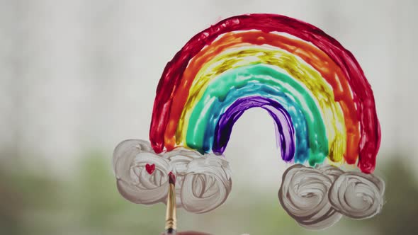 Concept Of The Pandemy - Painting rainbow during Covid-19 quarantine at home alt