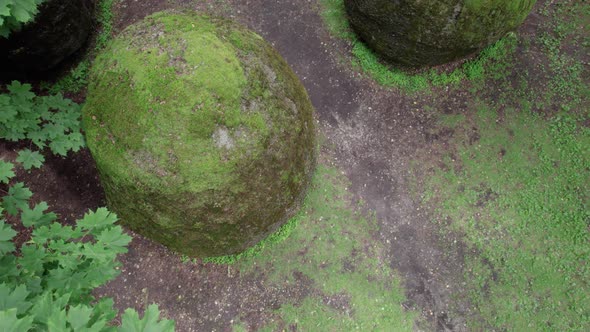 slow drone overflight rocks in the form of huge eggs overgrown with moss Europe park near Vilnius Li alt