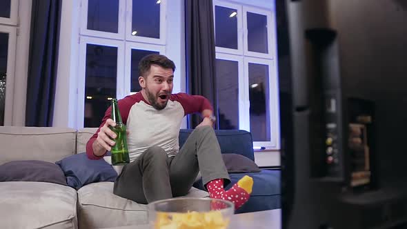 Bearded Guy Celebrating Goal which Scoring His Favourite Team and Drinking Beer alt