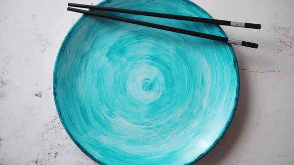 Turquoise Hand Painted Ceramic Serving Plate with Wooden Chopsticks on Side alt