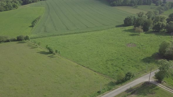 Aerial view of rural landscape, green fields meadows countryside village Sarremezan, France Summer