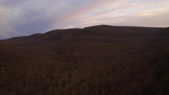 Aerial drone footage of a red and gold colored sunset golden hour in the Appalachian mountains durin alt