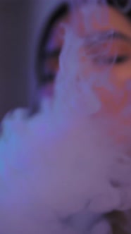 The Girl Smokes a Vape Releases a Lot of Steam