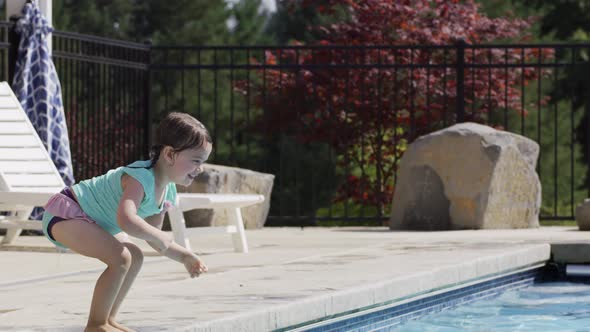Young girl jumps to father in pool
