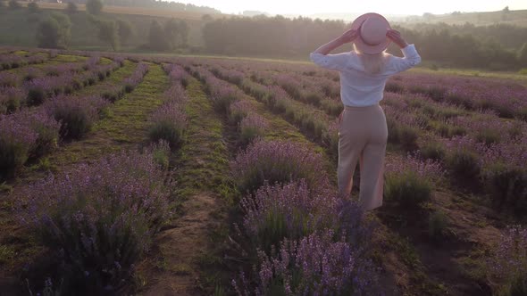 Drone Video of Free and Happy Young Woman Run in Pink and Purple Lavender Fields at Sunset