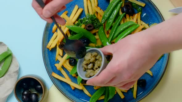 Vertical Tabletop Video Chef Adds Capers to the Fried Potato Dish