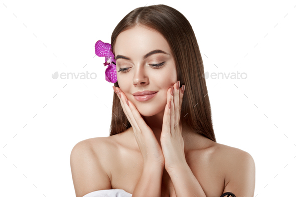 Woman beautiful portrait with flower orchid in hair isolated on white