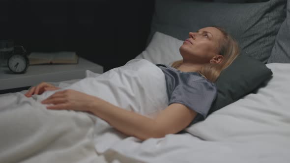 Relaxed Woman in Bed at Night