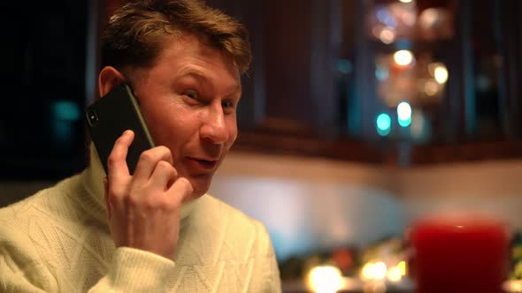 Closeup Happy Man on the Left Talking on Phone Laughing Sitting at Table with Romantic Dinner alt
