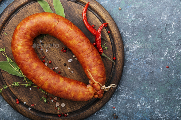 Smoked sausage on grey kitchen table - Stock Photo - Images