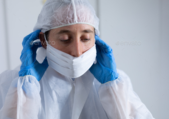 Healthcare worker wearing protective suit and face mask during coronavirus Covid19 pandemic