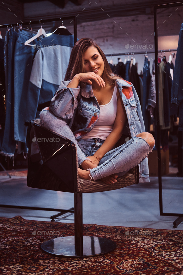 Beautiful girl posing in a fitting room of a clothing store
