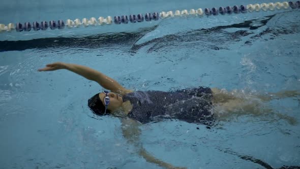 Woman Amateur Swimmer Performing Backstroke During Training, Slow Motion