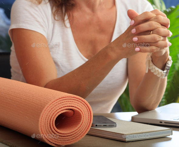 Woman and an exercise mat, corporate office background Stock Photo by rawf8