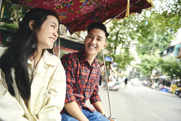 Cheerful couple traveling by Vietnamese mode of transport - Stock Photo - Images