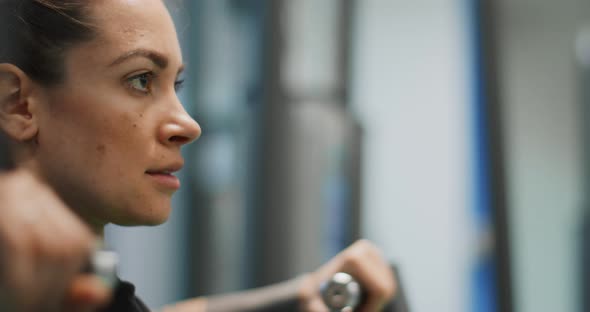Woman Exercising at Chest Press Machine alt