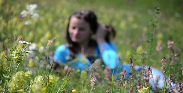 Girl Relaxing In A Flower Field 1