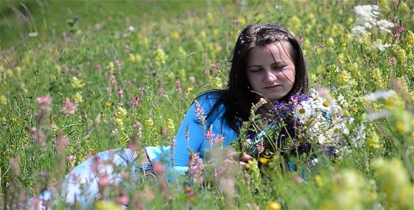 Girl Relaxing In A Flower Field 2