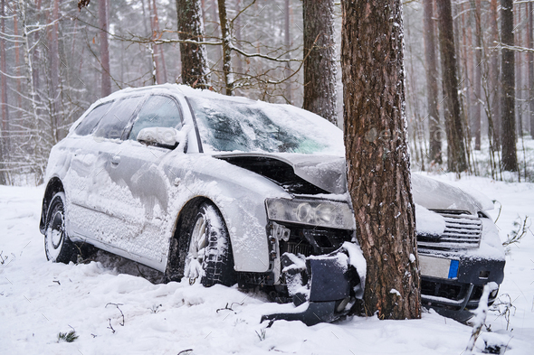 Broken car crashes into tree after losing control on slippery road in ...