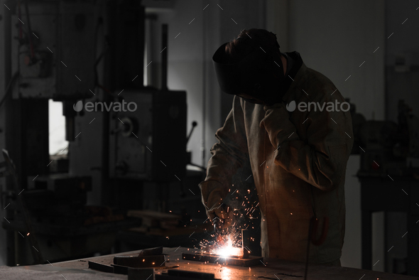 Front View of Worker in Protection Mask Welding Metal at Factory